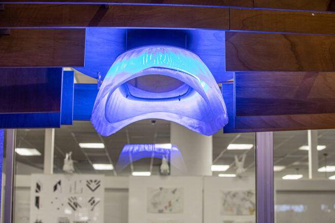 A close-up of a blue light on a wood canopy.