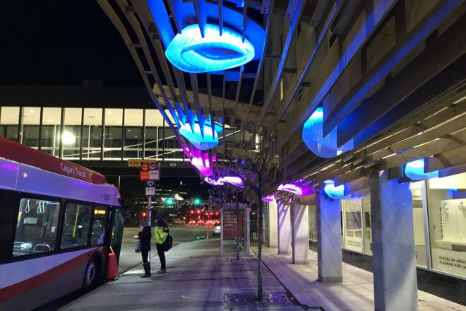 A wood canopy with blue and purple lights.