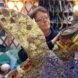 A person working on an art sculpture of a turtle.