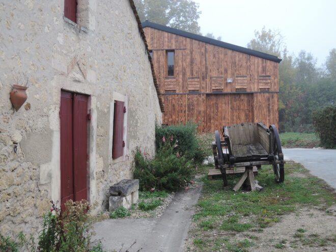 wagon and stone building near wood wine cellar