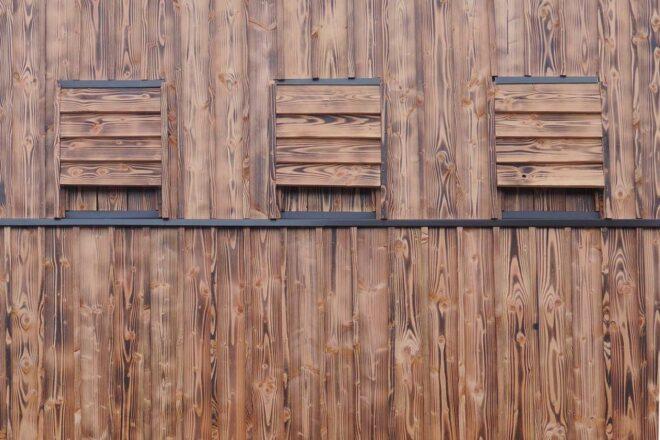 wooden bat houses on the exterior of a wooden building