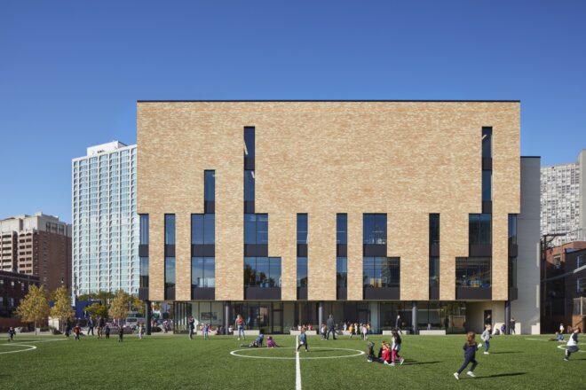 soccer field outside brick school building