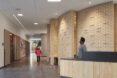 person at wood reception desk