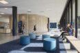 large blue round seats in brick school building