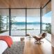 bed and chair facing glass wall