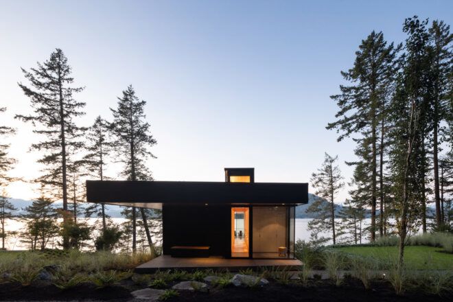 charred cedar and glass cabin near trees