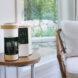 single-serve coffee machine on wood end table in a living room