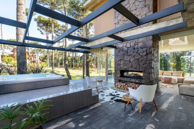 two white chairs facing a stone fireplace