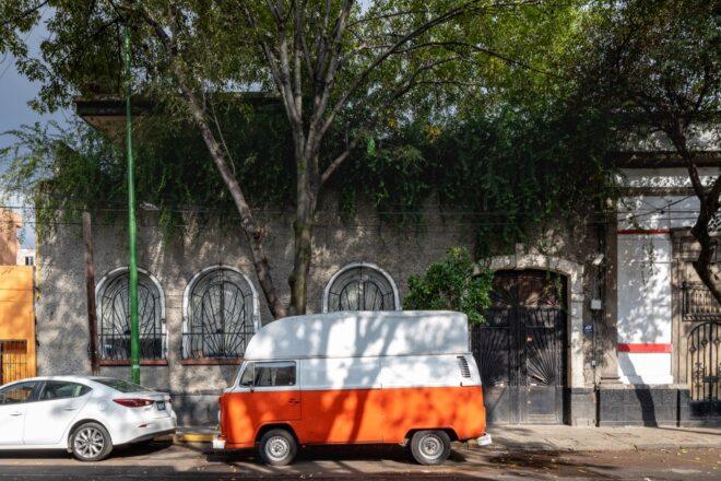 A streetview of the building, with a white and orange van parked outside.