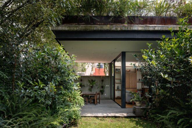 A patio area surrounded by greenery.