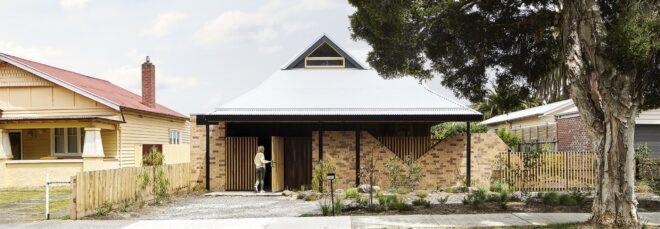 brick and wood home with gabled roof