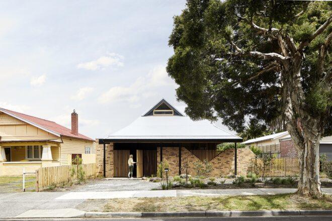 brick and wood home with gabled roof