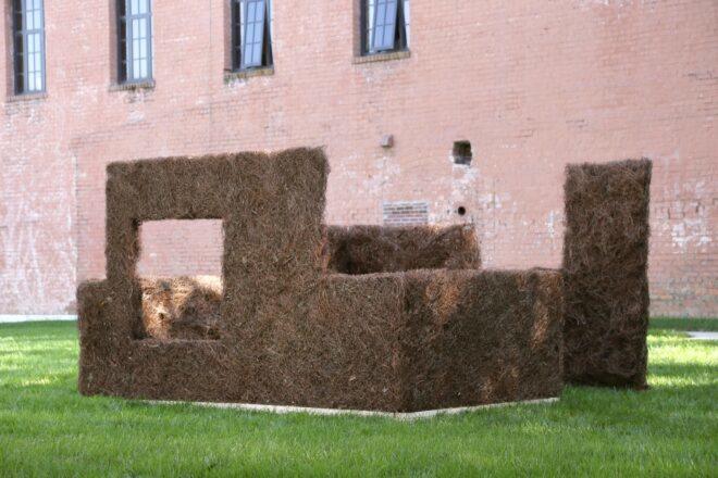 large structure made from plant scraps