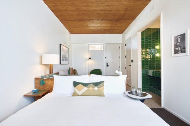 white hotel room with green accents