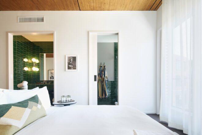 white hotel room with wood ceiling