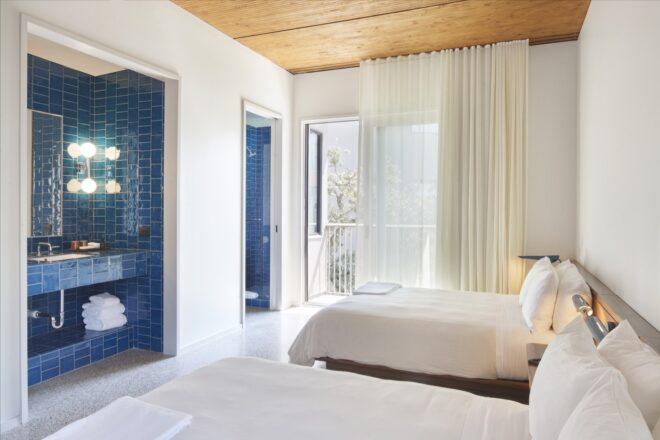 white hotel room with two beds