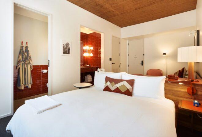 white hotel room with red accents