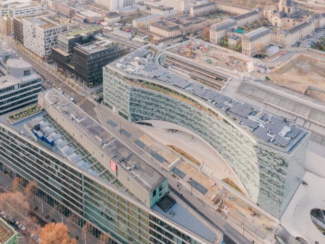 solar panels across roof of a glass building