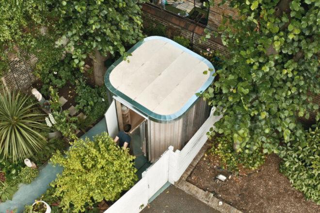 An aerial view of a person entering a modular garden pod room.