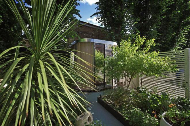 A pathway leading to a modular garden pod room.