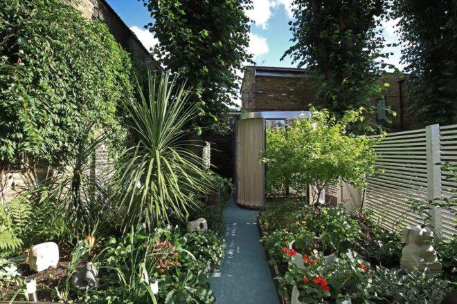 A pathway leading to a modular garden pod room.