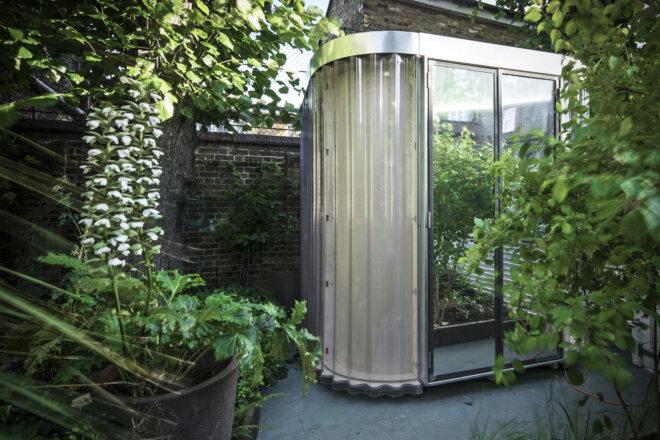 A modular pod room in a garden.