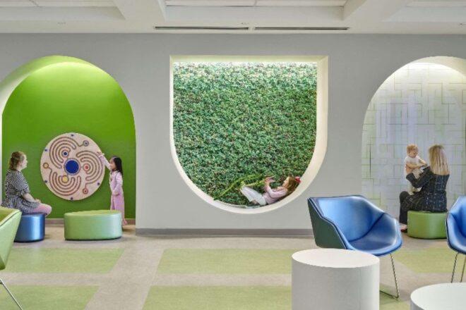 kids lounging in reading seats with green walls