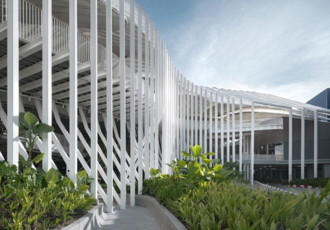 white mall building next to lush garden