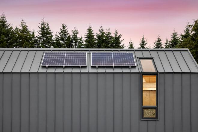 A rooftop with solar panels on top.