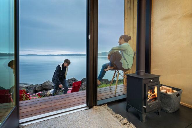 A living room with an open door connecting it to the outdoors.