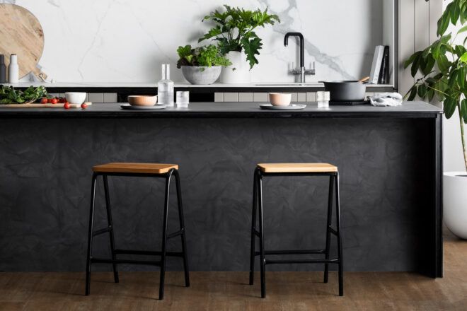 tan and black bar stools against black kitchen counter