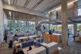An interior study area with study tables and students milling around.