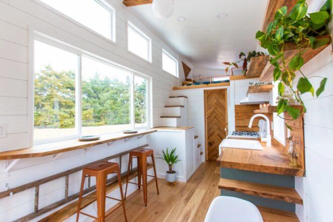 tiny home with white shiplap walls and wood furniture