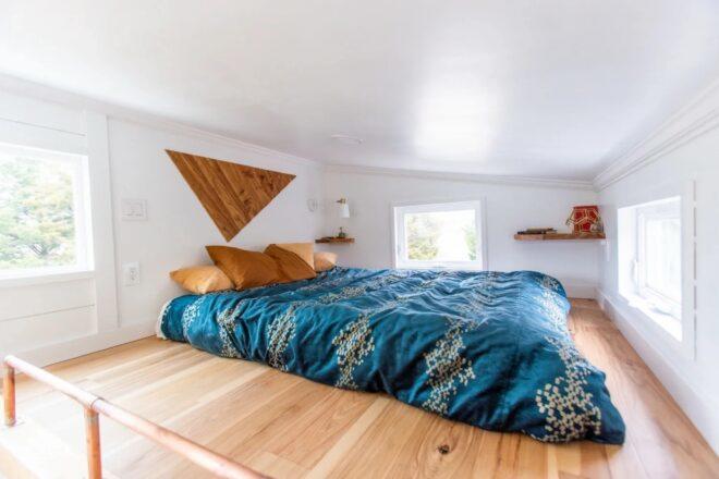 large blue bed in a loft