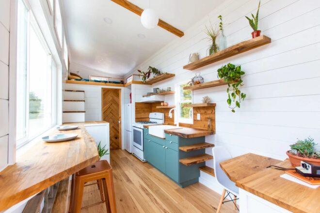 tiny home with wood shelves, white shiplap walls and copper accents