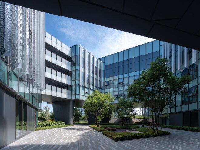 courtyard in between multiple glass buildings