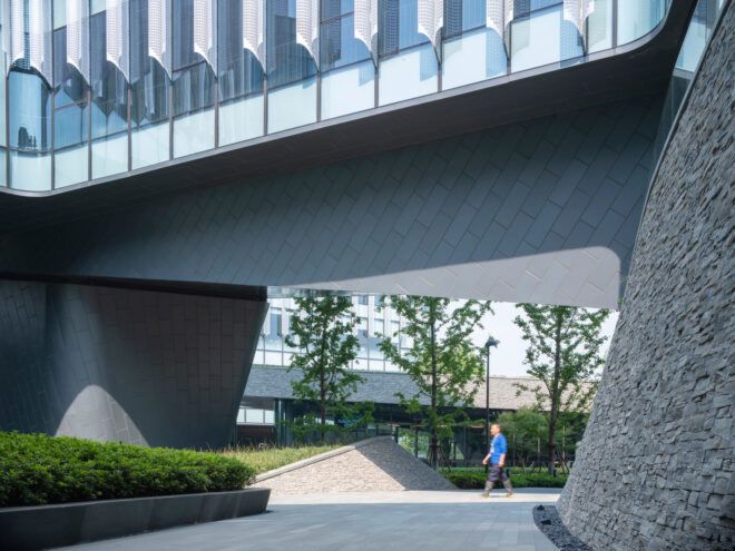 person walking under a raised building