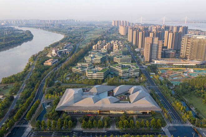 aerial view of large glass building near water