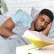 bird-shaped air monitor next to person sleeping in bed