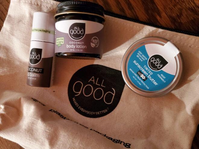 glass and tin skincare containers on a canvas bag