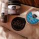 glass and tin skincare containers on a canvas bag
