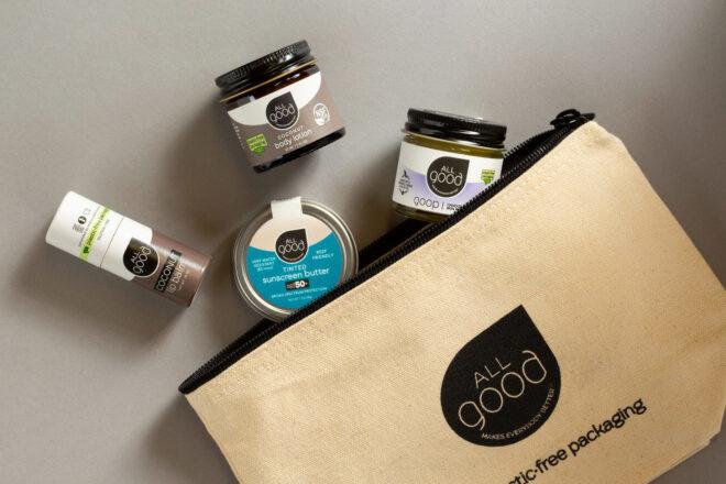 glass and tin skincare products spilling out of a canvas bag