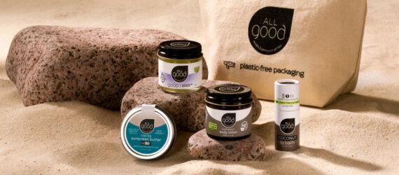 skincare products in glass and tin jars on a sandy beach