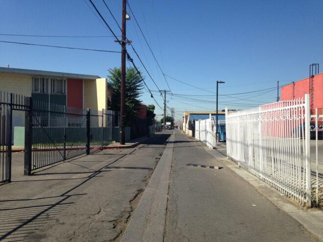 before image of empty alley surrounded by old factory buildings