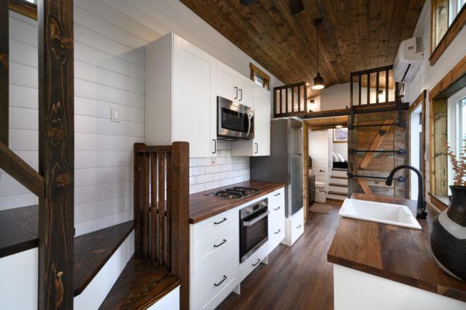 tiny home interior with white shiplap walls and dark wood accents