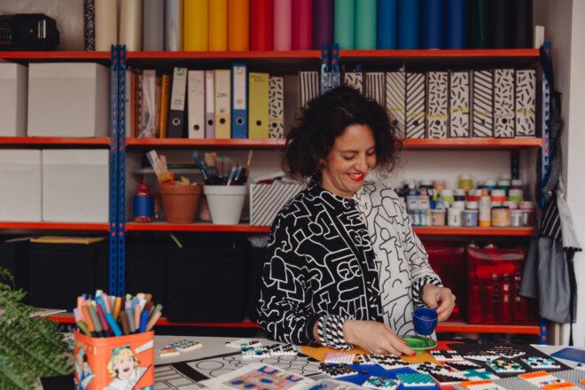 photo of Camille Walala smiling in a colorful art studio