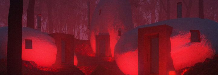 Three rounded, stone shaped buildings lit up with red lights.