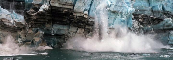 melting ice from a glacier falling into ocean