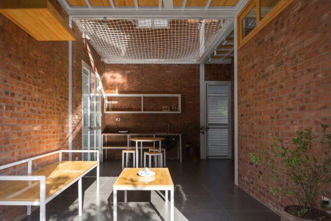 wood bench under a netted upper floor