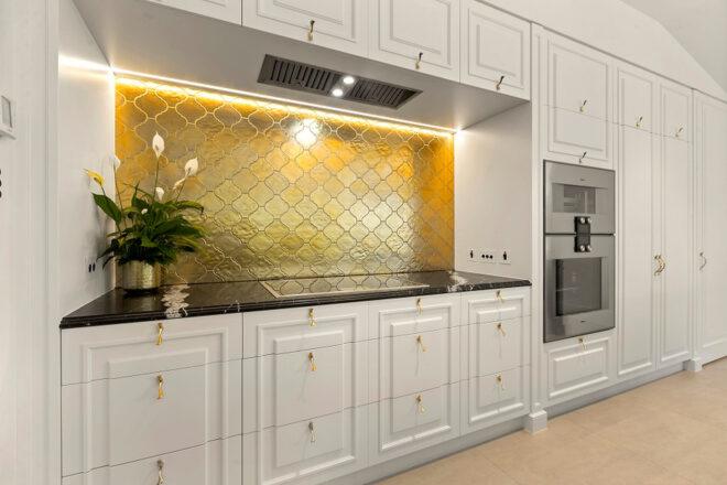 white and gold kitchen with energy-efficient appliances